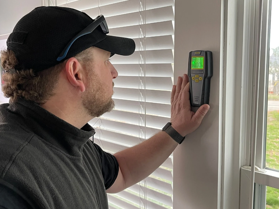 Certified home inspector performing moisture inspection in Maine